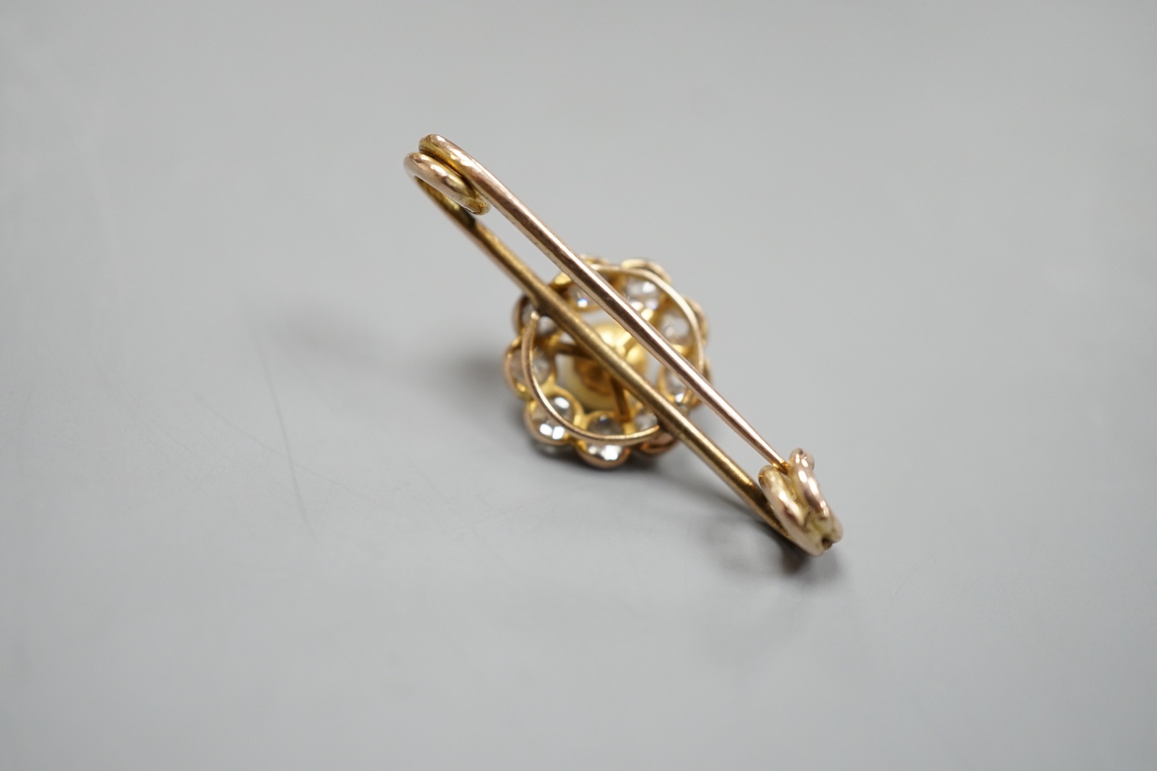 A yellow metal, cultured pearl and diamond cluster set bar brooch, 31mm, gross weight 2.7 grams.